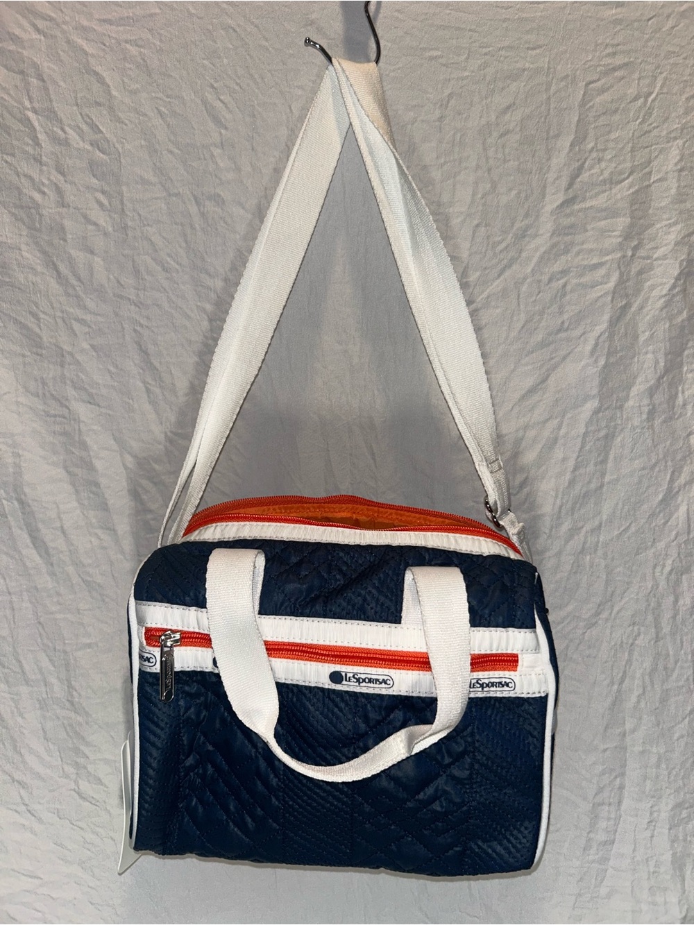 NWT LeSportsac Navy Quilted Crossbody Duffel with White Straps and Orange Accent
